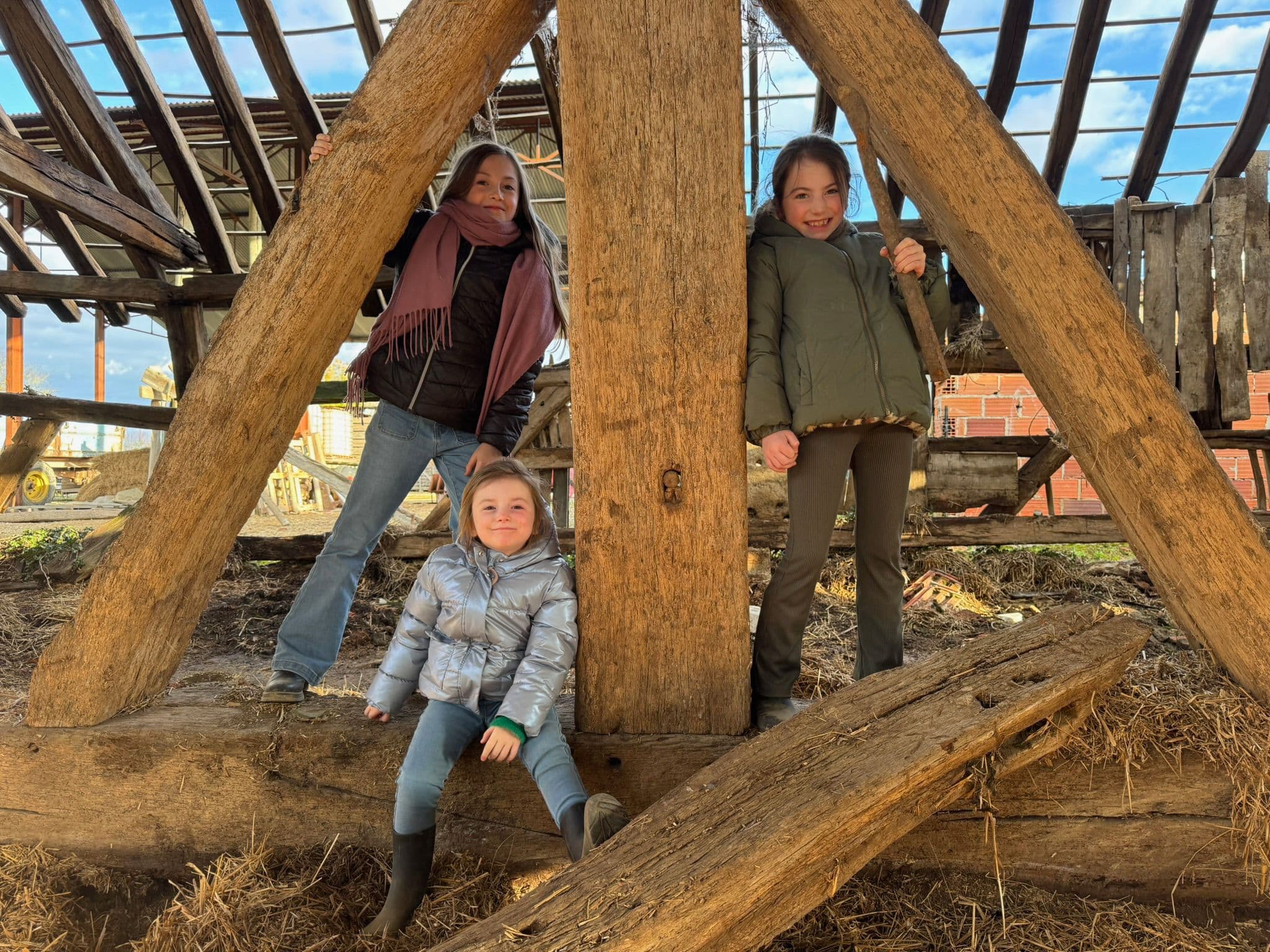 Our three daughters playing in the barn — the next generation.